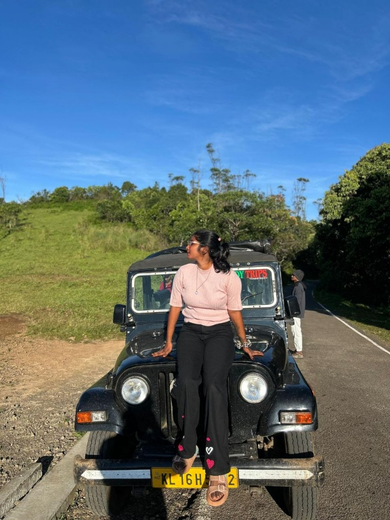 Guest posing on the bonnet of Thekkady Trips 4x4 Jeep in Gavi
