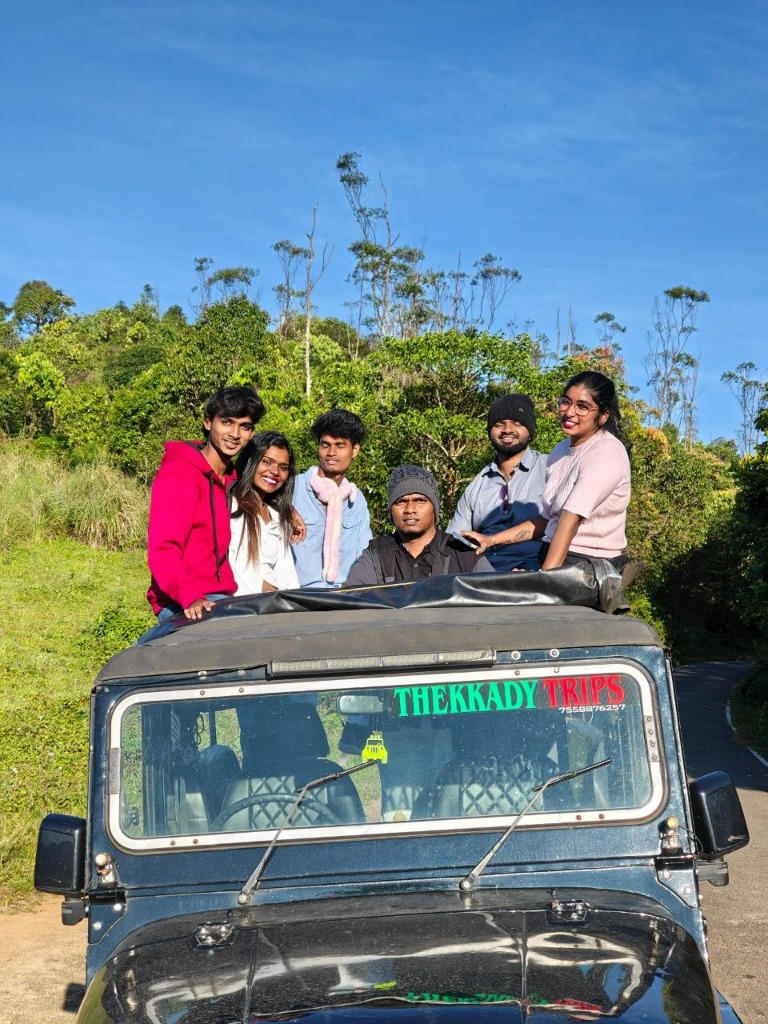 Happy group of friends on Thekkady Trips safari jeep in Gavi