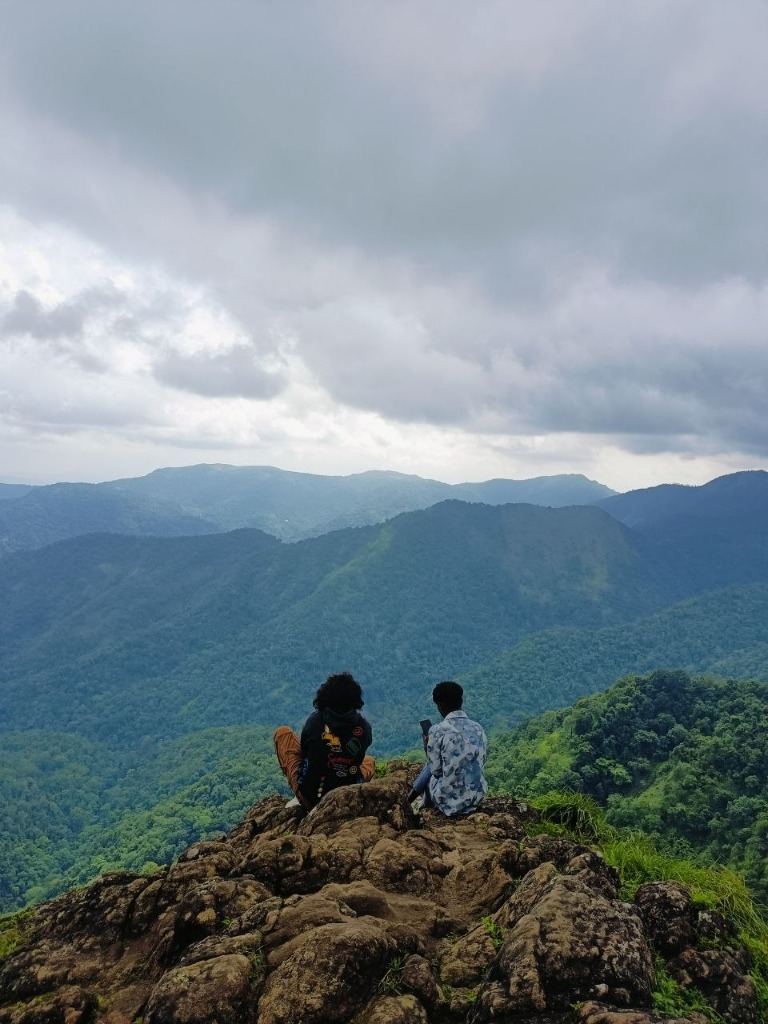 Travelers atop Parunthumpara Eagle Rock Summit